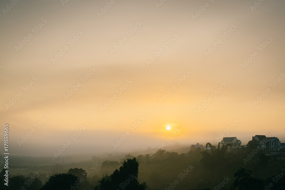 Beautiful mountain landscape at sunrise with fog