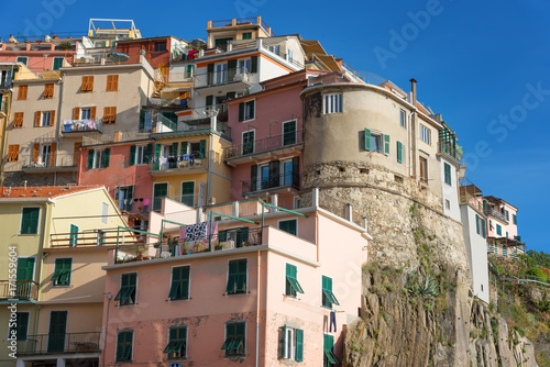 Magnificent daily view of the Manarola village in a sunny summer day. Manarola is one of the five famous villages in Cinque Terre (Five lands) National Park. Liguria, Italy, Europe
