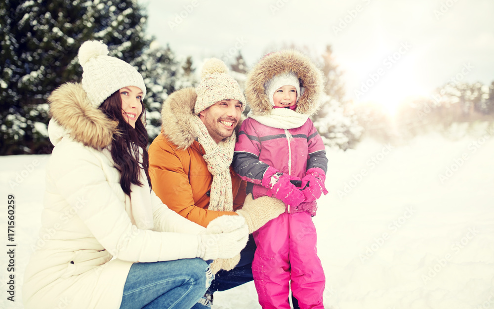 Fototapeta premium happy family with child in winter clothes outdoors