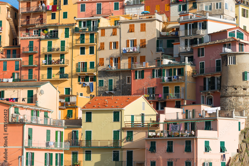 Picturesque view of the colorful houses along the main street in a sunny day in Manarola. Manarola is one of the five famous villages in Cinque Terre (Five lands) National Park. Liguria, Italy, Europe