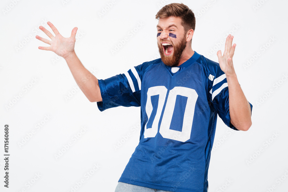 Screaming excited man fan in blue t-shirt standing isolated Screaming excited man fan in blue t-shirt standing isolated