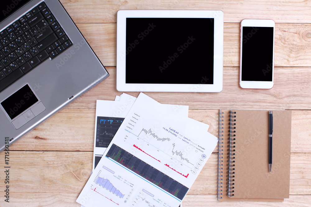 Home office for business Smartphone and a tablet and a laptop on the wooden background Home office for business Smartphone and a tablet and a laptop on the wooden background