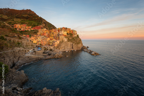 Magnificent sunset view of the Manarola village. Manarola is one of the five famous villages in Cinque Terre (Five lands) National Park. Liguria, Italy, Europe
