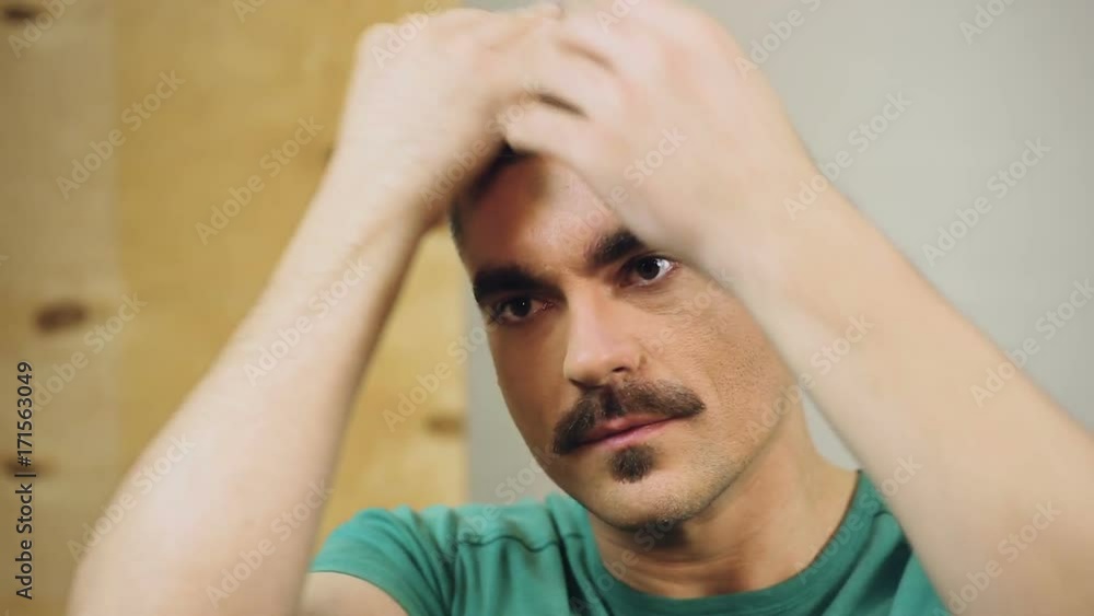 Confident and narcissistic alpha male modeling his hairstyle before going out Confident and narcissistic alpha male modeling his hairstyle before going out