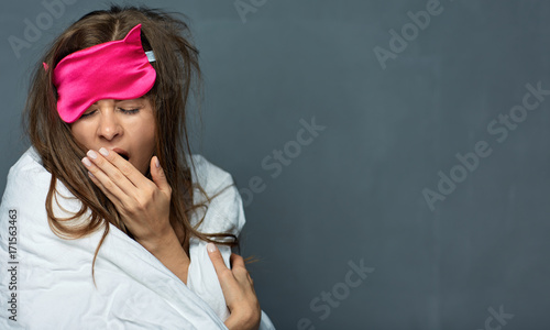 Quadro su tela Portrait of yawning woman with blanket.