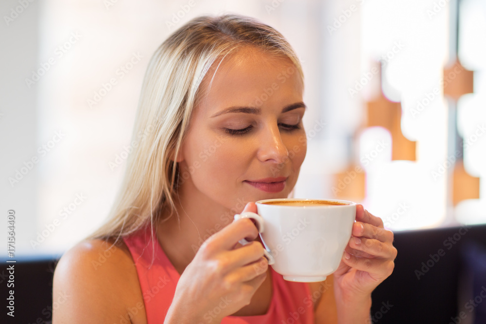 close up of woman drinking coffee at restaurant close up of woman drinking coffee at restaurant