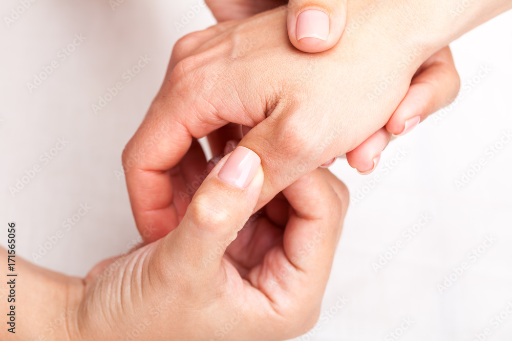 Woman receiving osteopathic treatment of her thumb Woman receiving osteopathic treatment of her thumb