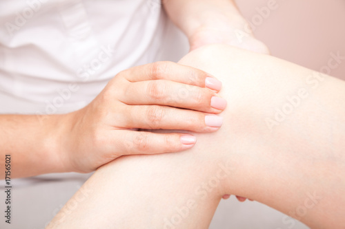 Woman receiving osteopathic treatment of her knee joint