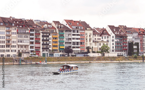 group of tourists crossing the Rhine river on a small boat in Basel - Switzerland photo