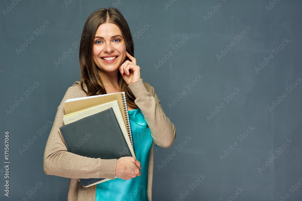 Smiling student or teacher holding books. Smiling student or teacher holding books.