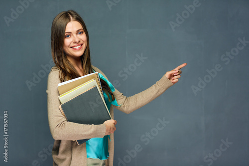 Toothy smiling girl student holding books