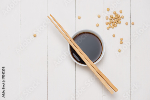 Bild auf Leinwand Soy sauce and soy bean with chopsticks on wooden table