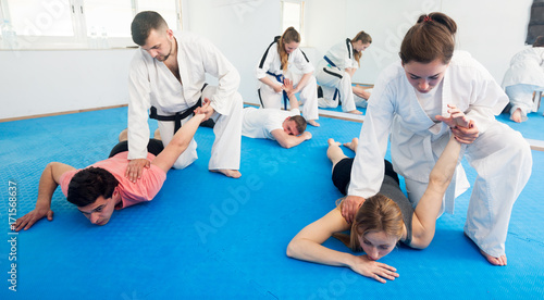 Adults training in pairs at taekwondo class