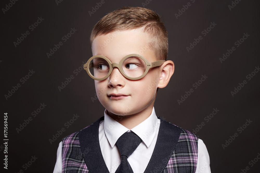 little boy in suit and glasses