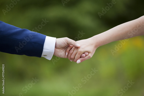 Wedding couple holding hands 