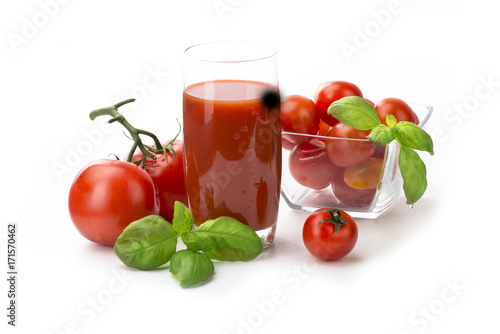 Tomato juice, tomatoes with basil in a glass isolate