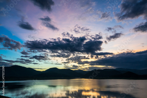 Sunset over the lake. Landscape sunset with beautiful clouds.