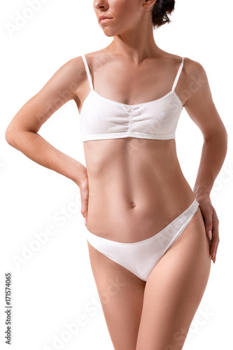 Slim tanned woman's body. Isolated over white background.