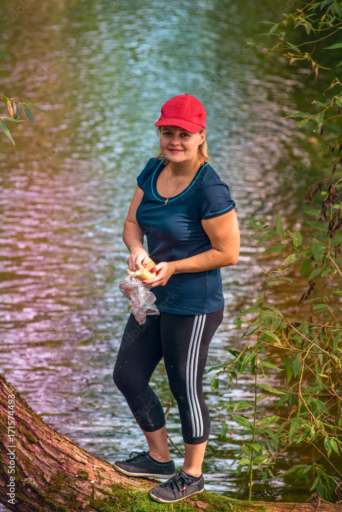 the woman at the river feeds the ducks the woman at the river feeds the ducks