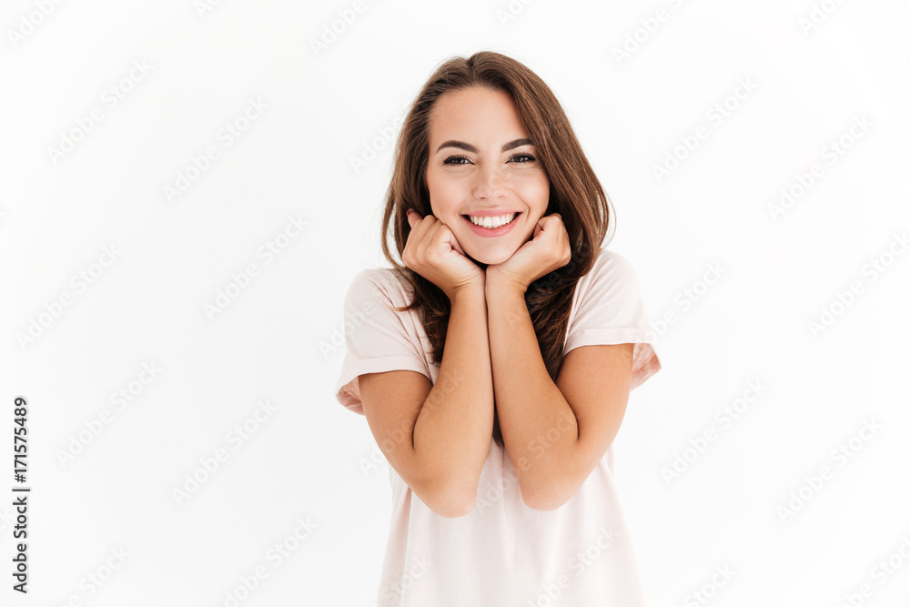 Pleased brunette woman reclines on hands and looking at camera Pleased brunette woman reclines on hands and looking at camera