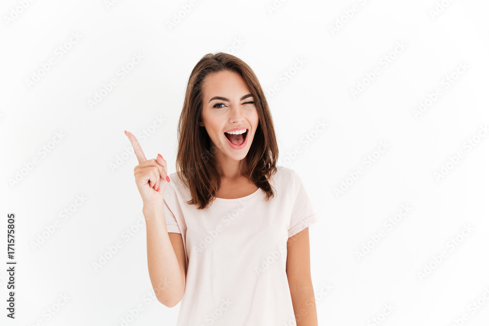Happy brunette woman having idea and winks at the camera Happy brunette woman having idea and winks at the camera