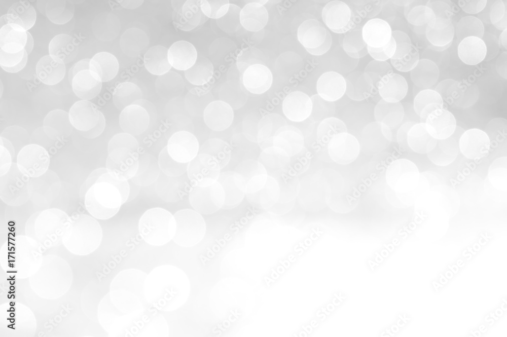 silver Sparkling Lights Festive background with texture. Abstract Christmas twinkled bright bokeh defocused and Falling stars. Winter Card or invitation.