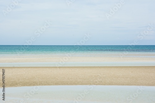 Beautiful tropical beach and sea landscape with blue sky background at Toei Ngam Beach, Chonburi, Thailand.