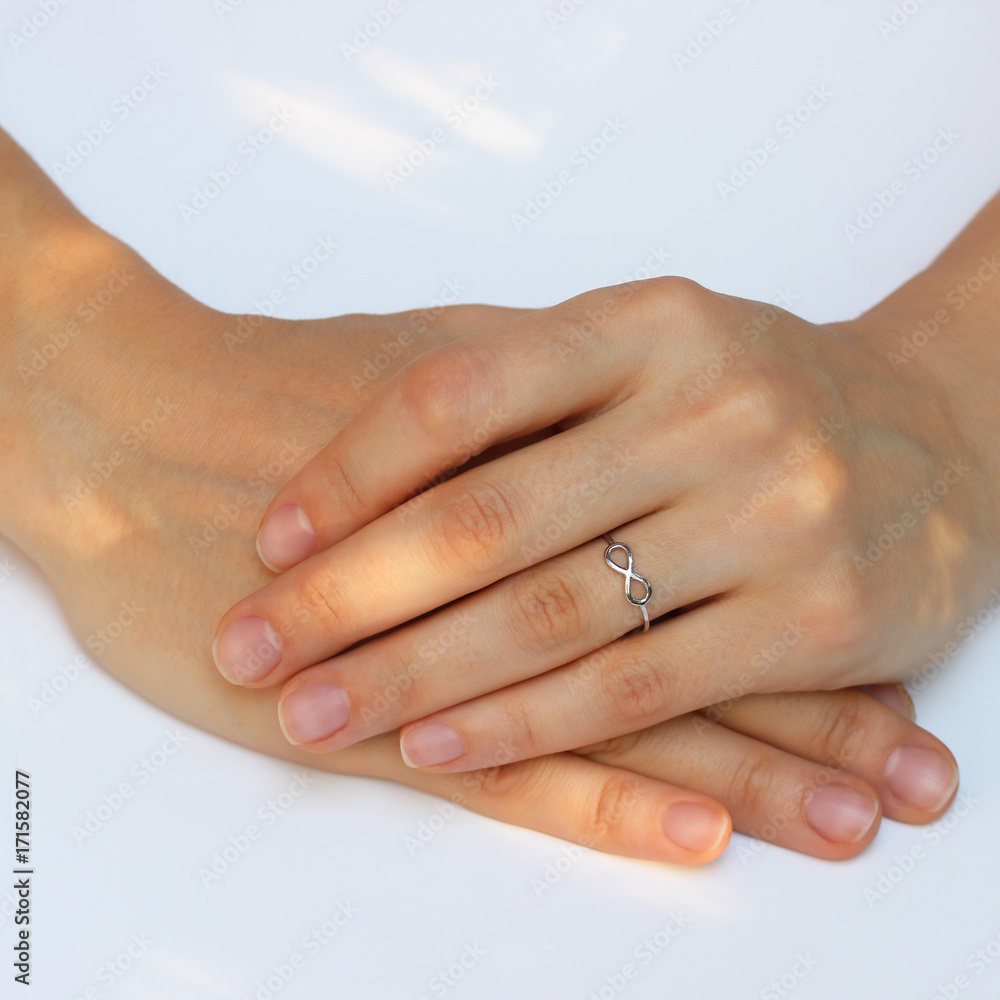 A woman's hand with silver rings and colored semi-precious stones A woman's hand with silver rings and colored semi-precious stones