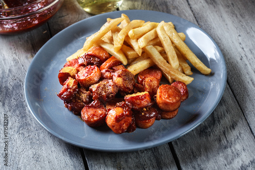 Traditional German currywurst - pieces of sausage with curry sauce