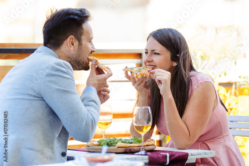 Love Couple Enjoying Pizza in a Restaurant