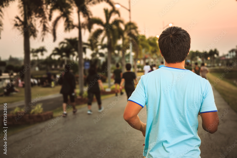 Naklejka premium Men are jogging in the park.