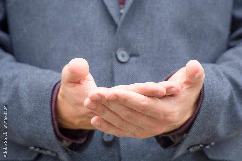 Close up hands of a male public speaker while giving a speech. 