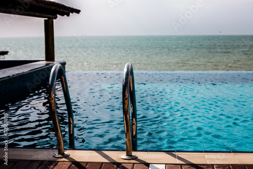 Swimming pool and metal handrail, bar on a pool with Black Sea view 