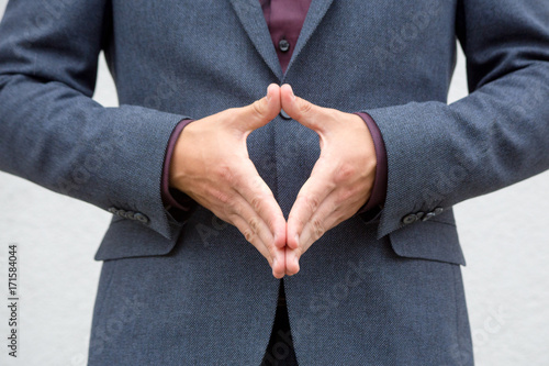 Close up hands of a male public speaker while giving a speech. 