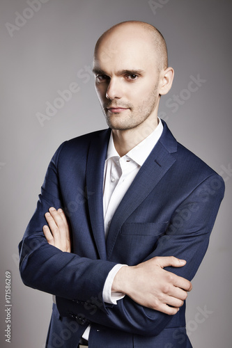  Pensive Businessman with Arms Crossed