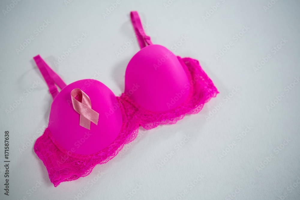 High angle view of Breast Cancer Awareness ribbon on pink bra High angle view of Breast Cancer Awareness ribbon on pink bra