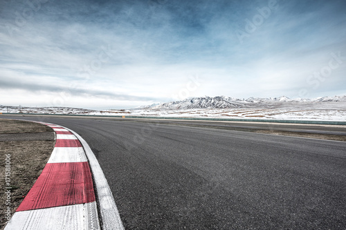 empty asphalt road with snow mountains in blue sky