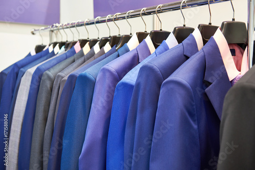 Men's suits with shirts in clothing store