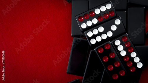 Chinese dominos and casino gambling concept with a Pai Gow tiles hand made of a Wong and a Gong on red background with copy space © Victor Moussa