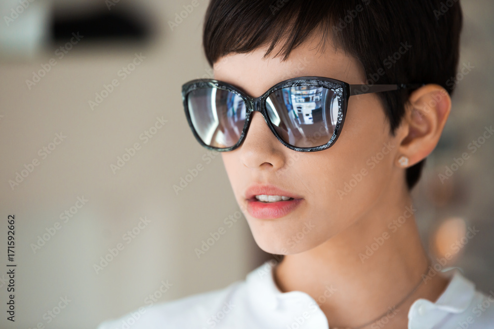 Beautiful young perfect model posing in fashion sunglasses Beautiful young perfect model posing in fashion sunglasses