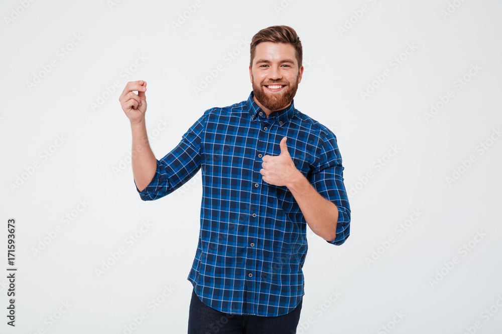 Happy bearded man holding copy space and showing thumbs up Happy bearded man holding copy space and showing thumbs up