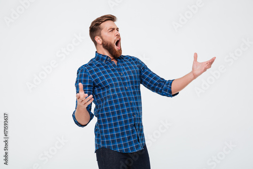 Young attractive bearded man singing loud