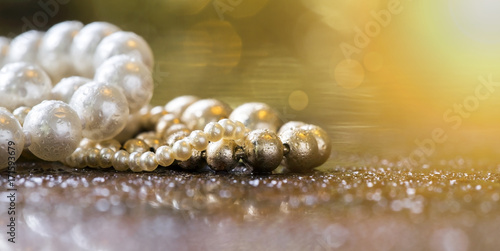 Website banner of beautiful white and golden pearls closeup