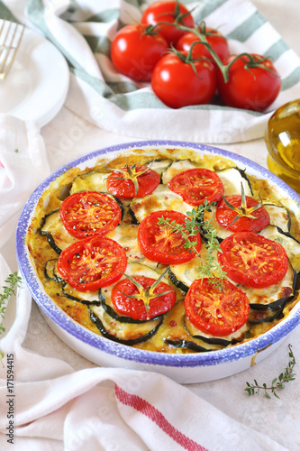 Zucchini and tomatoes gratin with bechamel sauce and cheese