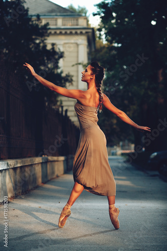 Young beautiful ballerina dancing on the sidewalk © djile