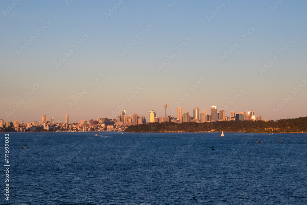Sydney skyline under morning golden light.