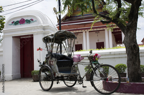 Vintage retro tricycle bike or rickshaw of thai style at front of gate of Wat Songtham Worawihan