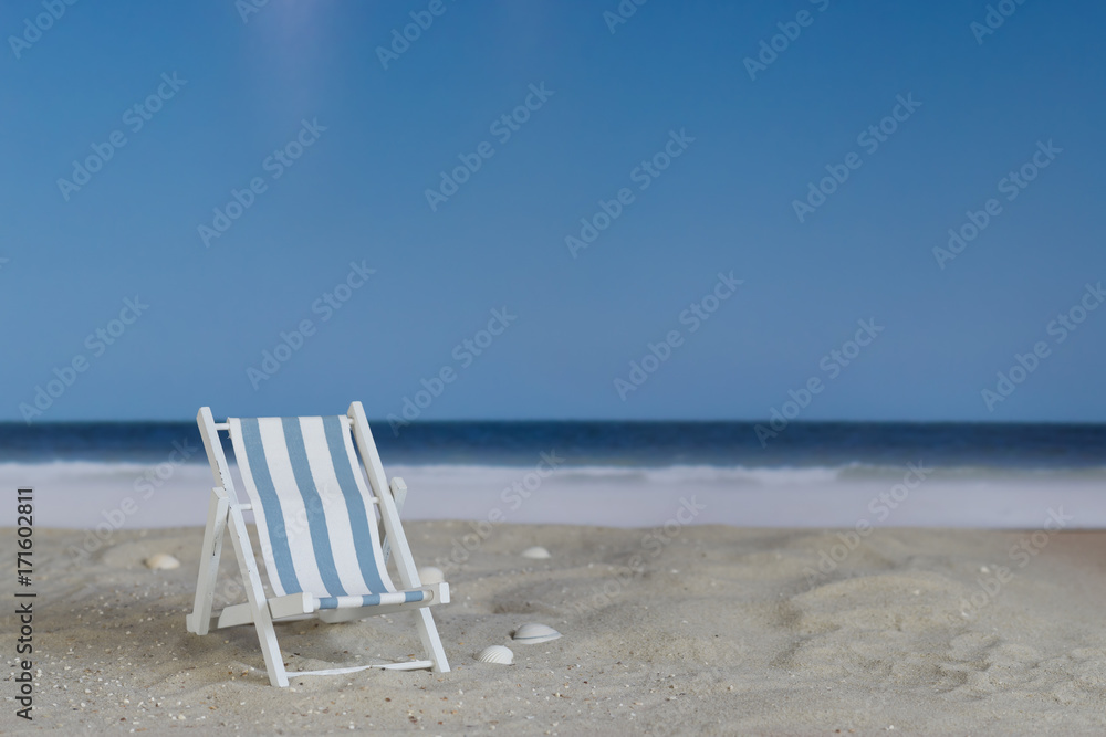 Blue white striped deck chair on the beach