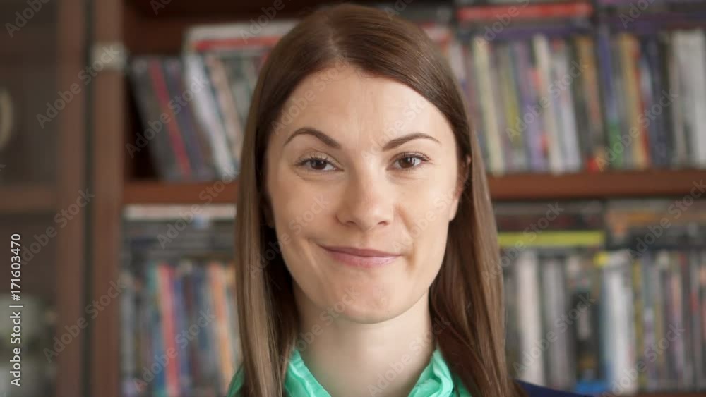Closeup portrait of cheerful joyful content happy young woman sincere powerful emotions on face. Eyebrow raised. Cupboard on background Closeup portrait of cheerful joyful content happy young woman sincere powerful emotions on face. Eyebrow raised. Cupboard on background