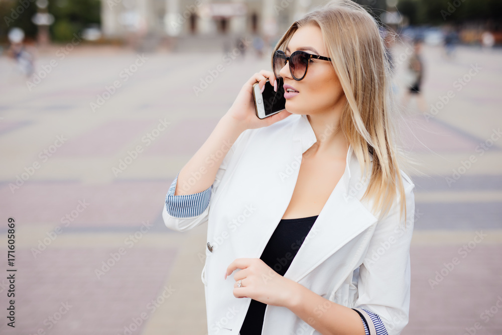 Young beauty Woman use of mobile phone at street